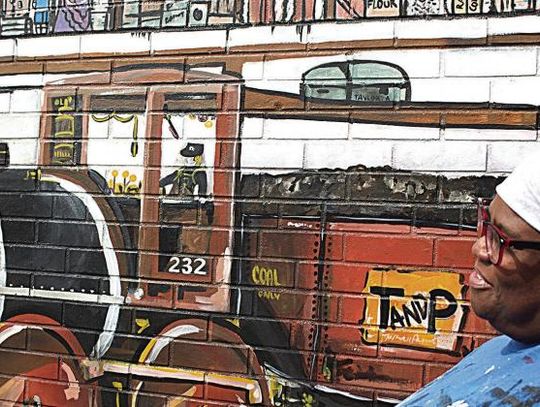 Artist showcases history in downtown NB mural