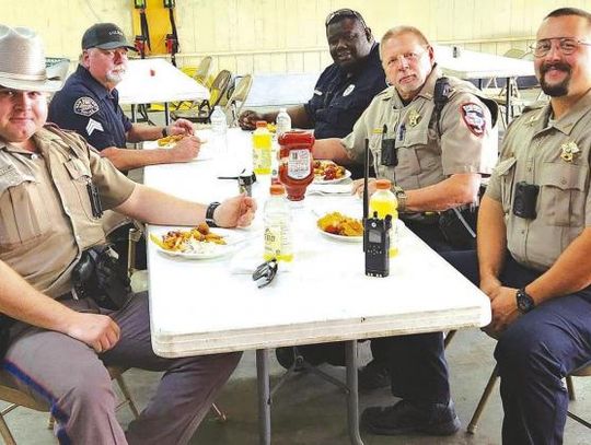 Officers from area law enforcement agencies joined together for some fresh fish cooked by the New Boston Fire Department for a recent local fundraiser